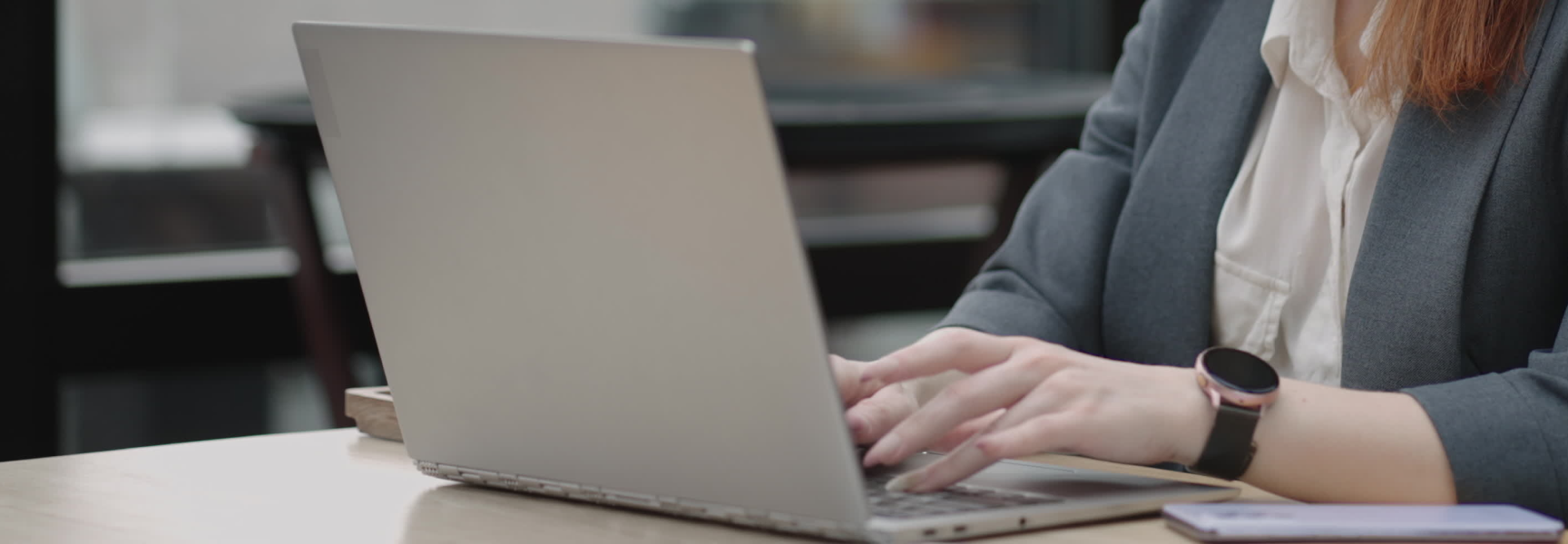 Woman in suit using laptop